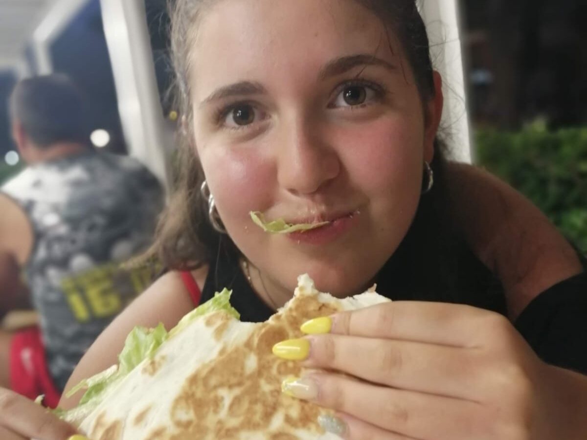 Alice, the writer, eating piadina, a popular street food in Emilia-Romagna