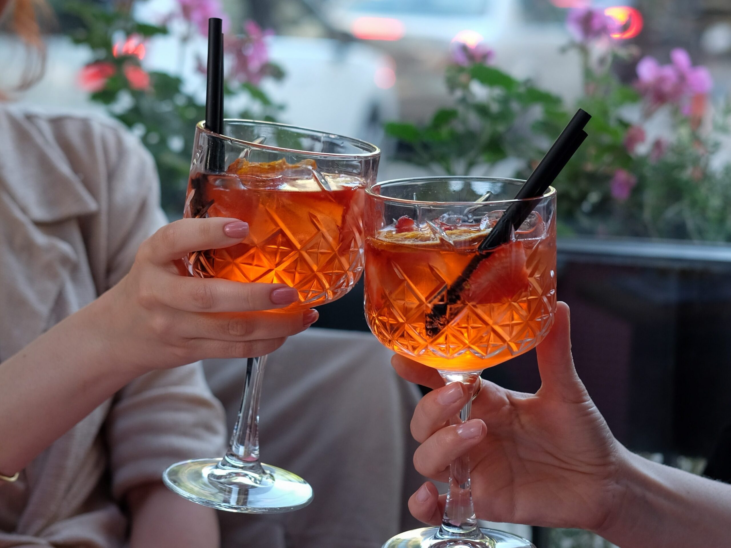 Two people drinking Spritz during an aperitivo